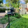 Multiple wrought iron garden spikes are used to set as a boundary to a small garden.